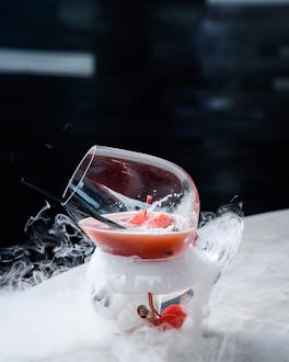 Ein roter Drink in einem Glas mit Strohhalm